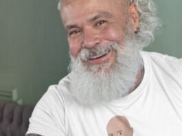 A bodybuilder daddy training with dumbbells