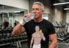 A muscular gray-haired man taking a selfie